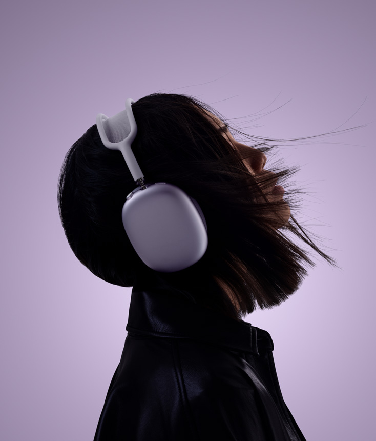 Profile of person wearing AirPods Max 2 headphones in purple color with head tilted up slightly