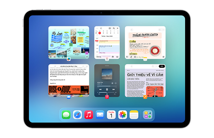 iPad, nằm ngang, màn hình hiển thị sáu cửa sổ mở thành hai hàng, bao gồm ứng dụng Lịch, ứng dụng Ghi Chú, Apple Music, và Safari